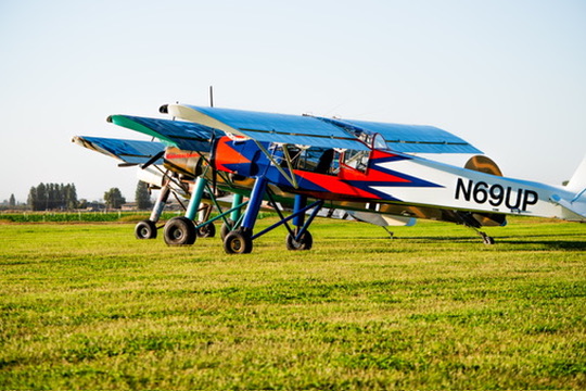 Blue and red Slepcev Storch N69UP close-up on a grass field